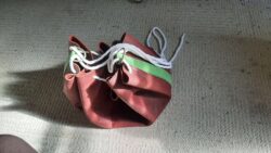 Commissioned hobo-style carry bag made from 8oz buffalo hide with hand-dyed veg-tan accents, cotton rope draw strap, and custom laser-engraved artwork.