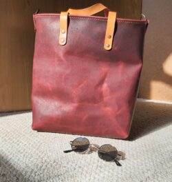 Handcrafted tote bag made from Volcano pull-up leather with Portofino straps, copper rivets, and copper strap D-rings.