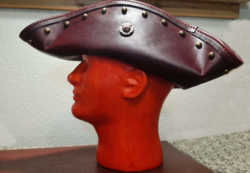 Handcrafted tricorn hat in Black Cherry Volcano pull-up leather, finished with brass studs and a hammered copper accent medallion.